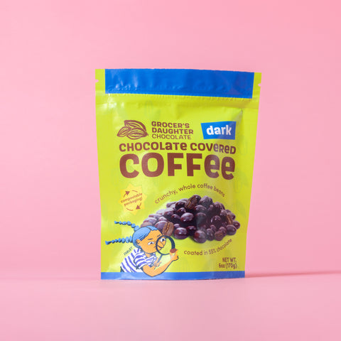 Packaging of Grocer's Daughter Chocolate Dark Chocolate Covered Coffee on a pink background