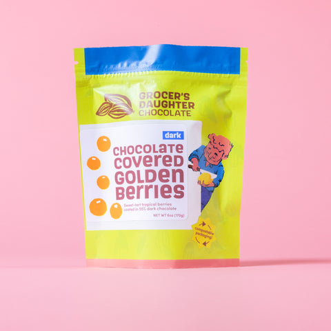Packaging of Grocer's Daughter Chocolate Covered Golden Berries on a pink background