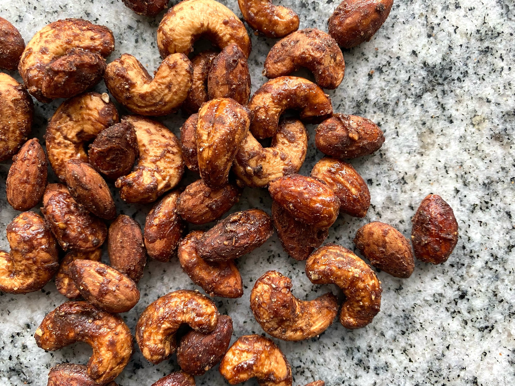 Sweet and spicy candied nuts on a granite countertop